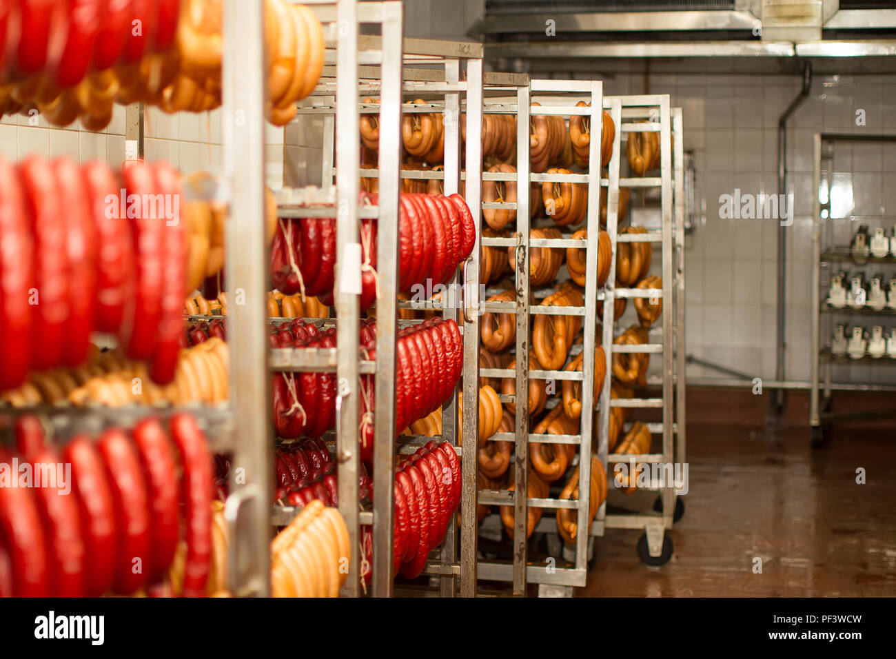 Sausages at the meat factory. Industrial cooking and smoking sausages