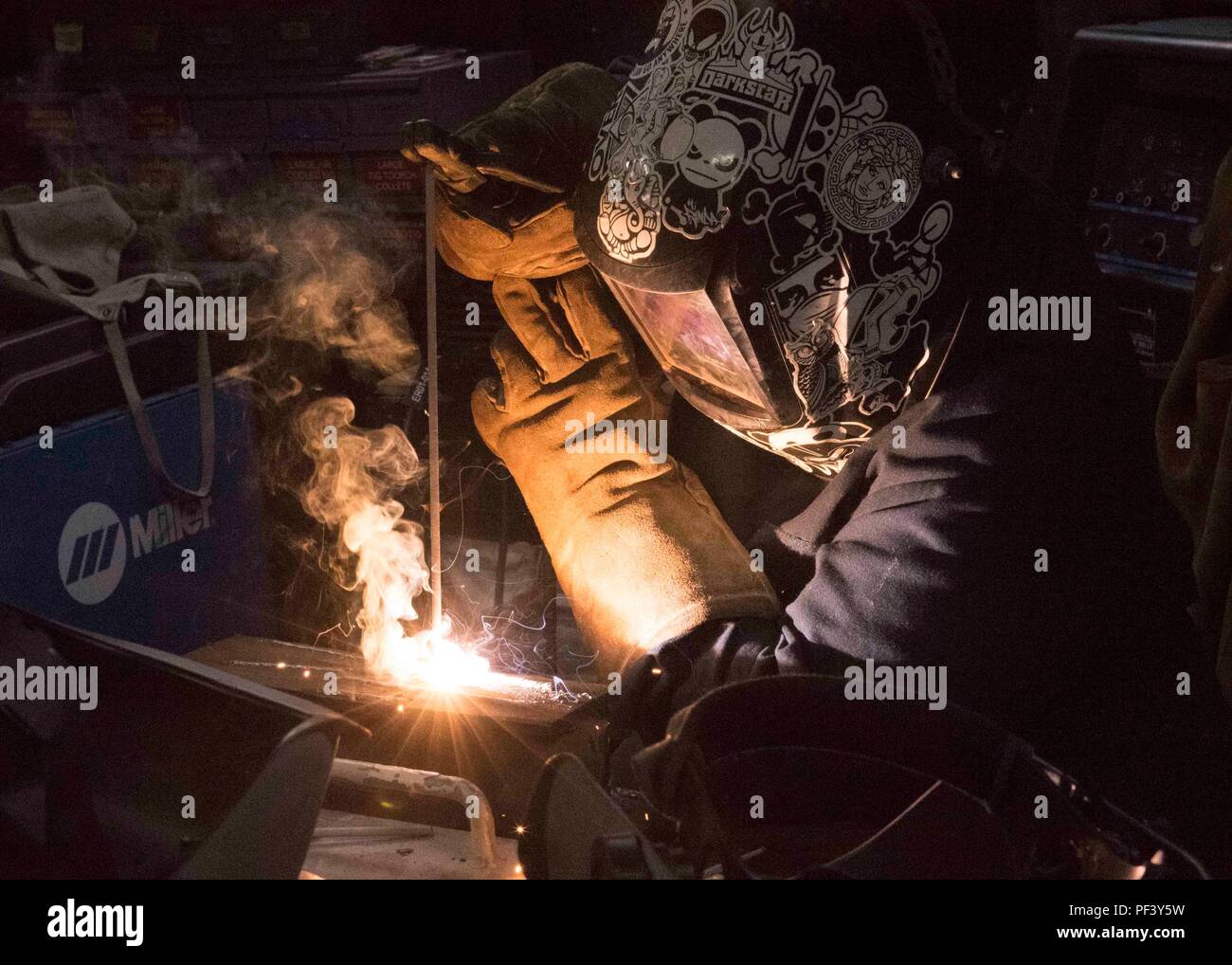 180814-N-MY760-152   PORTSMOUTH, Va. (Aug. 14, 2018) Hull Maintenance Technician Fireman Keriyate Lewis, from New Iberia, La., welds a metal brace aboard the aircraft carrier USS Dwight D. Eisenhower (CVN 69)(Ike). Ike is undergoing a Planned Incremental Availability (PIA) at Norfolk Naval Shipyard during the maintenance phase of the Optimized Fleet Response Plan (OFRP). (U.S. Navy photo by Mass Communication Specialist Seaman Apprentice Tyler Miller) Stock Photo