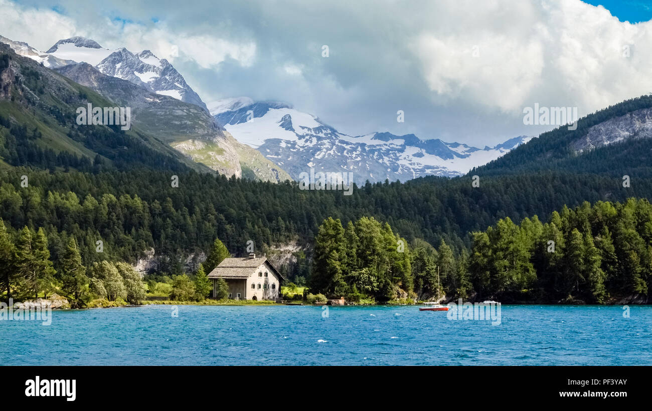 Lake Sils (or Silsersee; Lej da Sils) is a lake in the Upper-Engadine valley of Grisons, Switzerland. Stock Photo