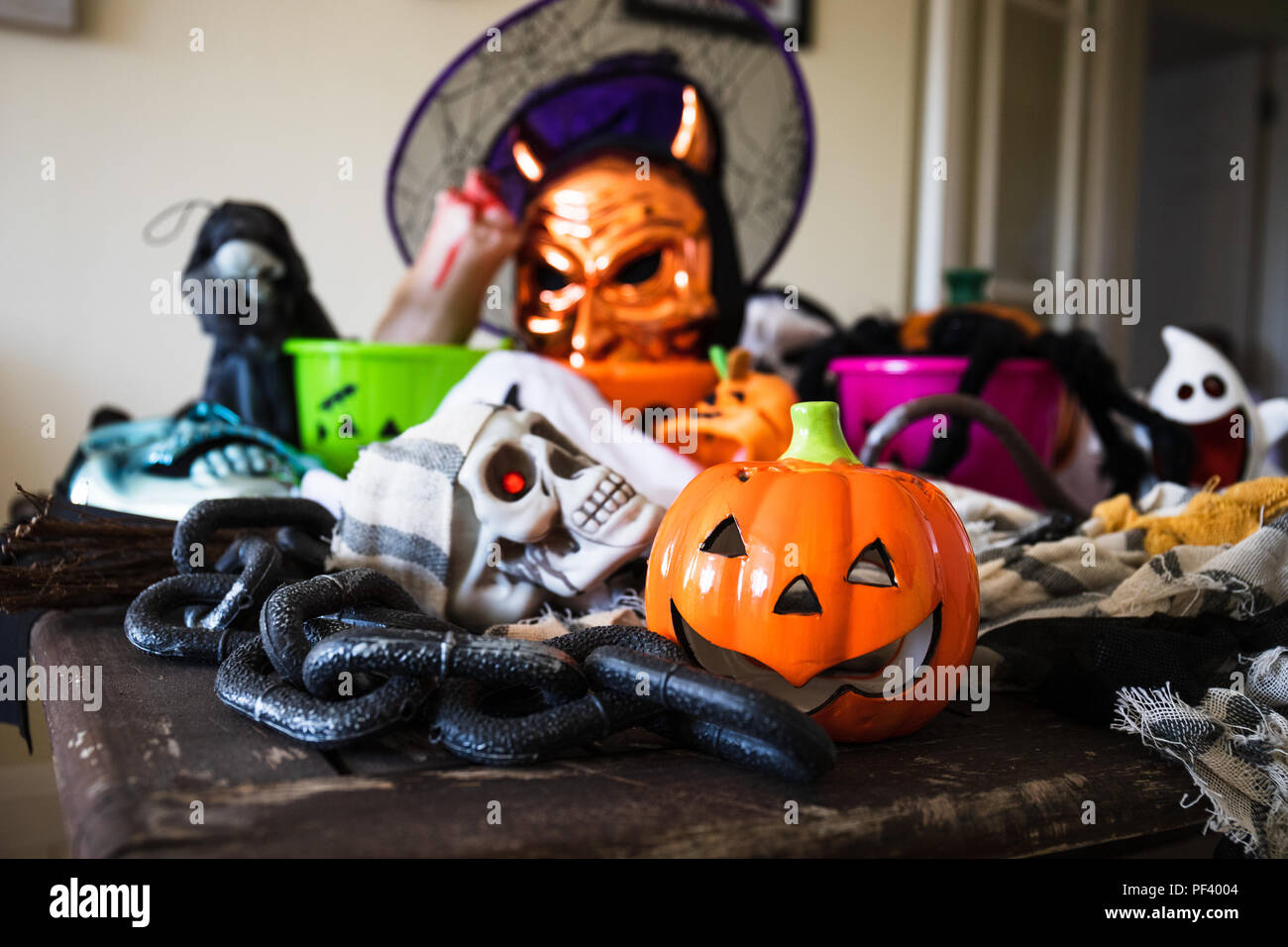 An old wooden table covered in all sorts of Halloween decorations Stock