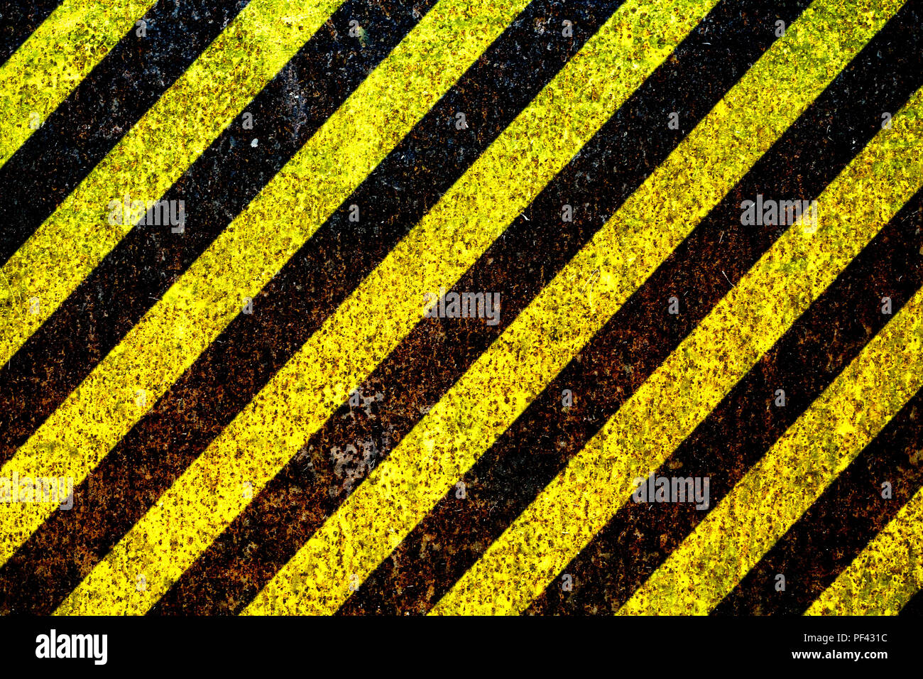 Warning sign yellow and black stripes painted over rusty metal plate as texture background. Concept for do not enter the area, caution, danger, hazard Stock Photo