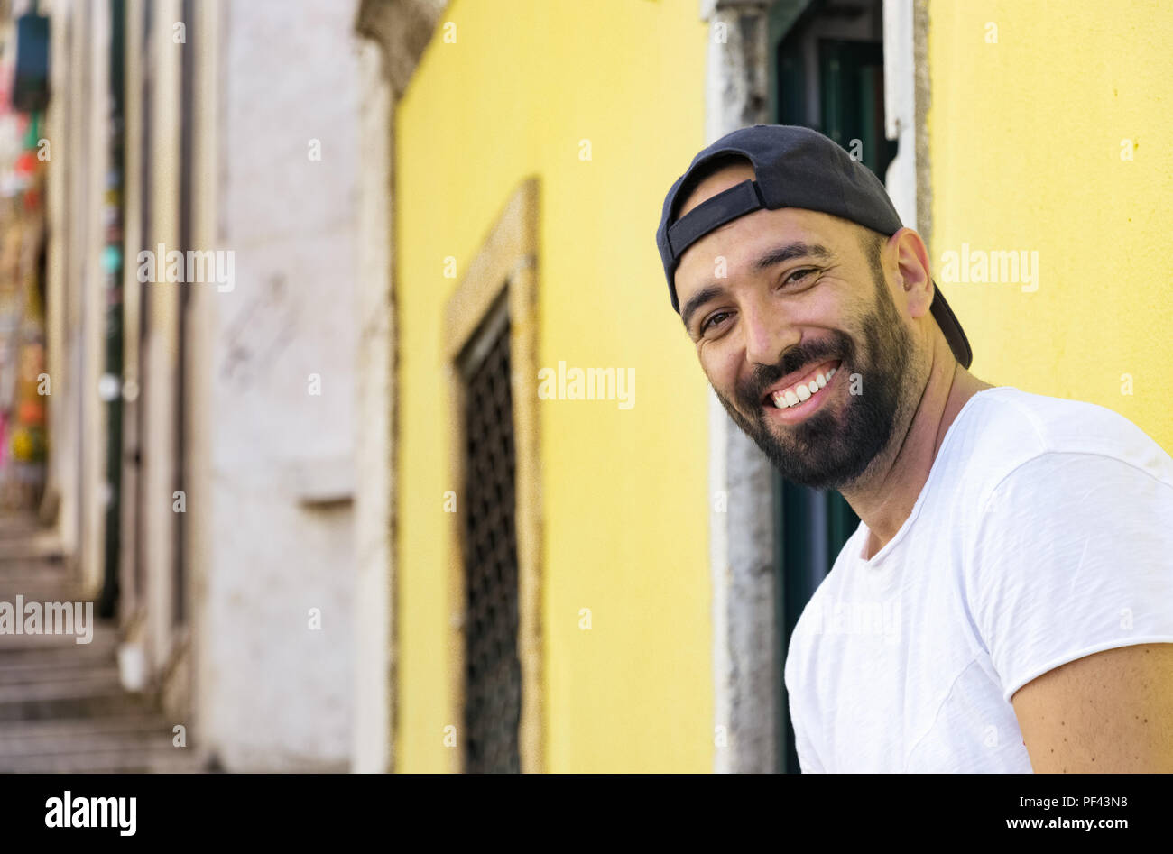 Portrait of a spanish man with beard smiling looking camera, wearing a