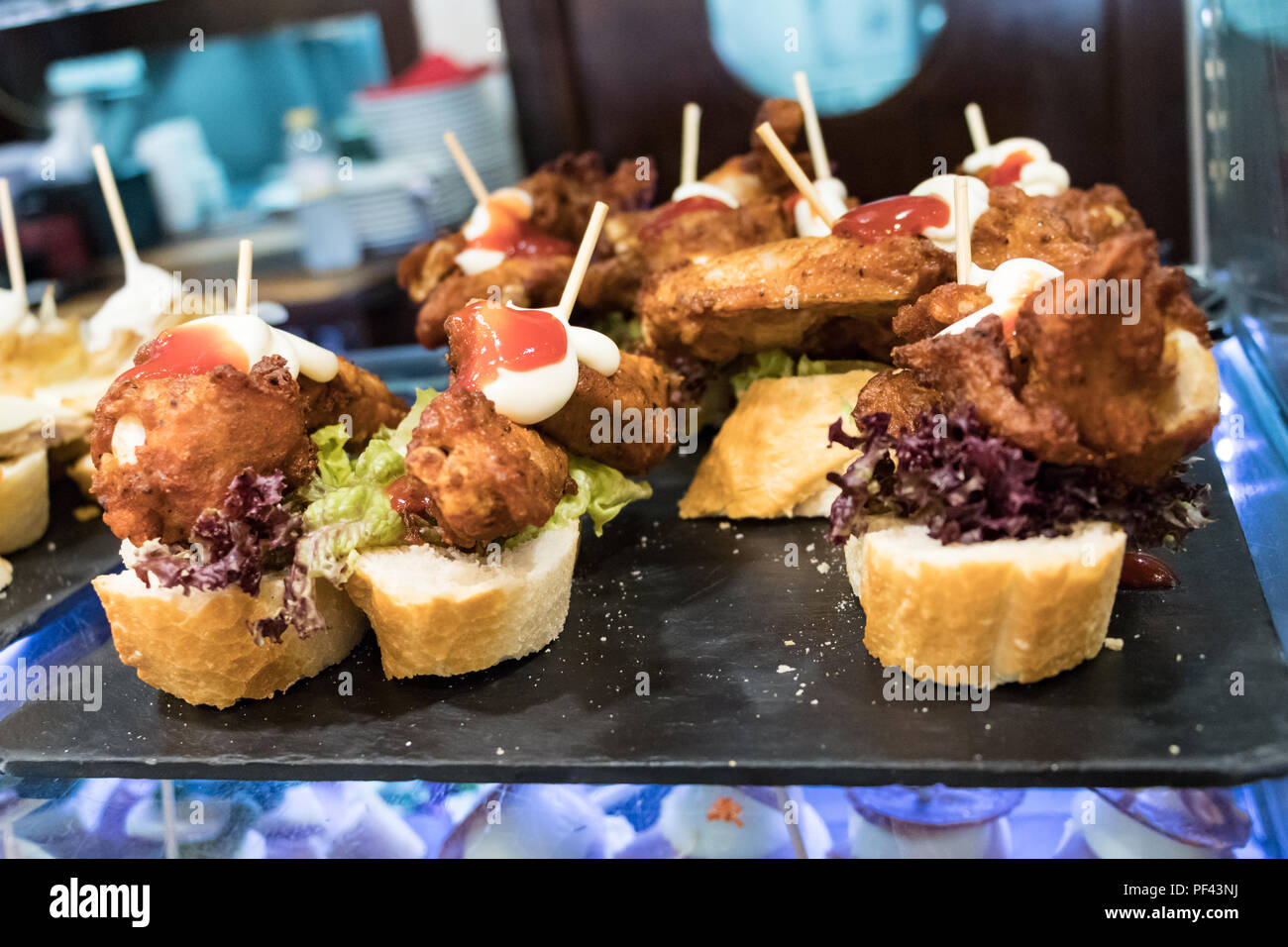 Typical spanish food tapas on a counter in a restaurant Stock Photo Alamy