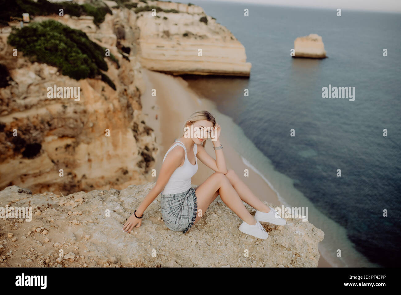 Girl Sitting On Edge Cliff High Resolution Stock Photography and Images