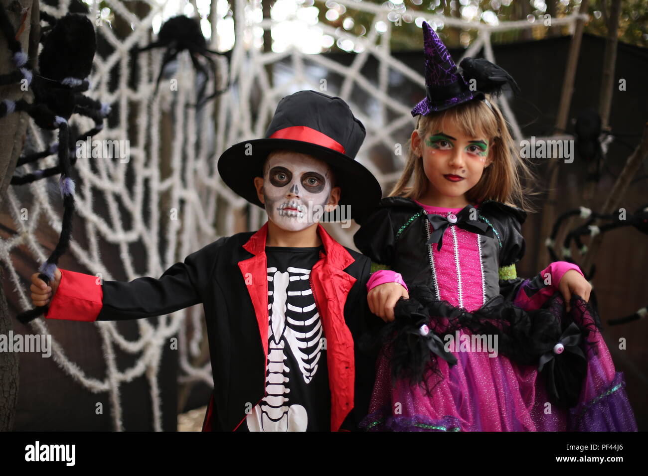 Halloween kids, Trick-or-treat. Kids wears costume of skeleton and witch for Halloween trick-or-treating party Stock Photo