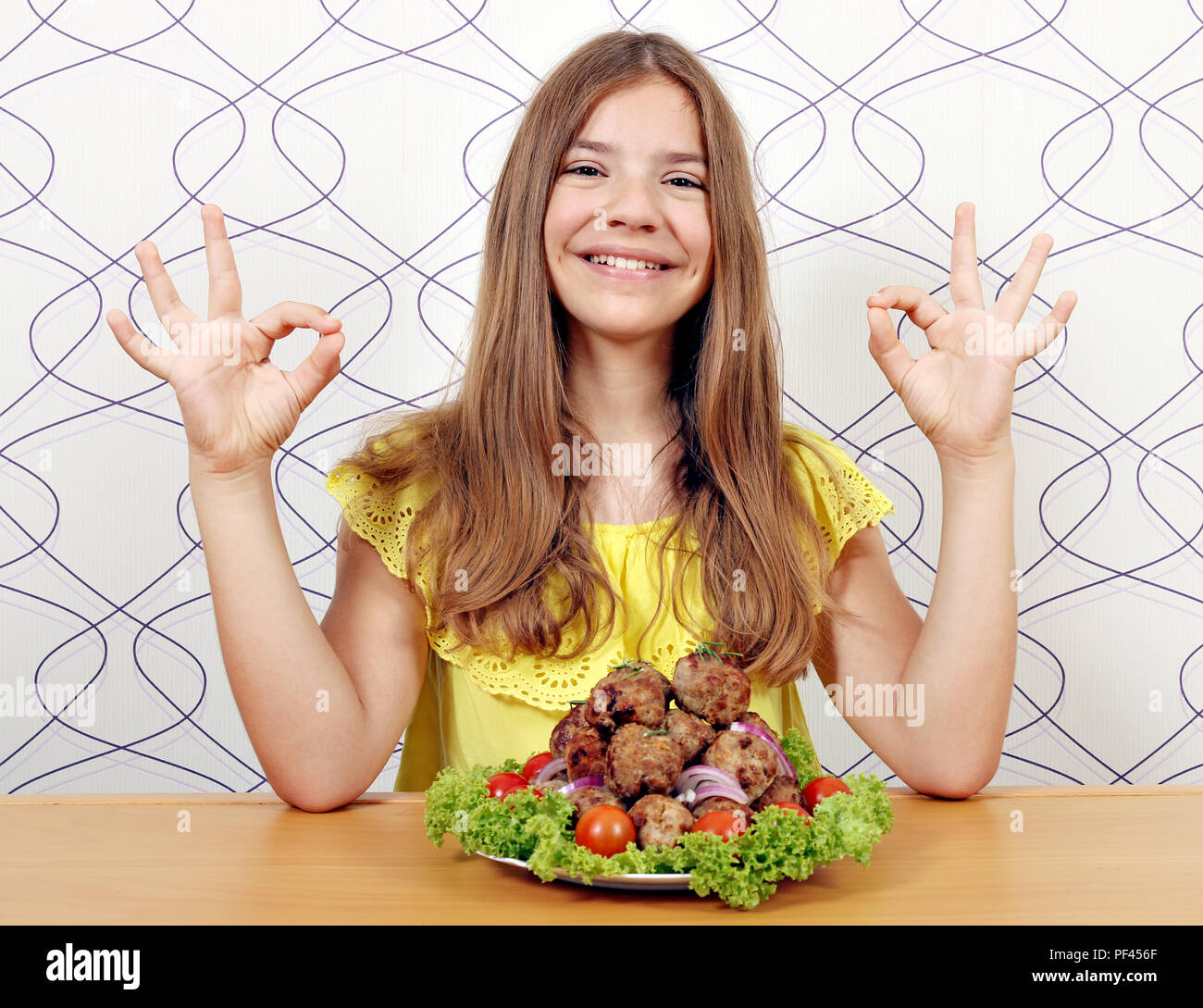 happy girl with meatballs and ok hand sign Stock Photo