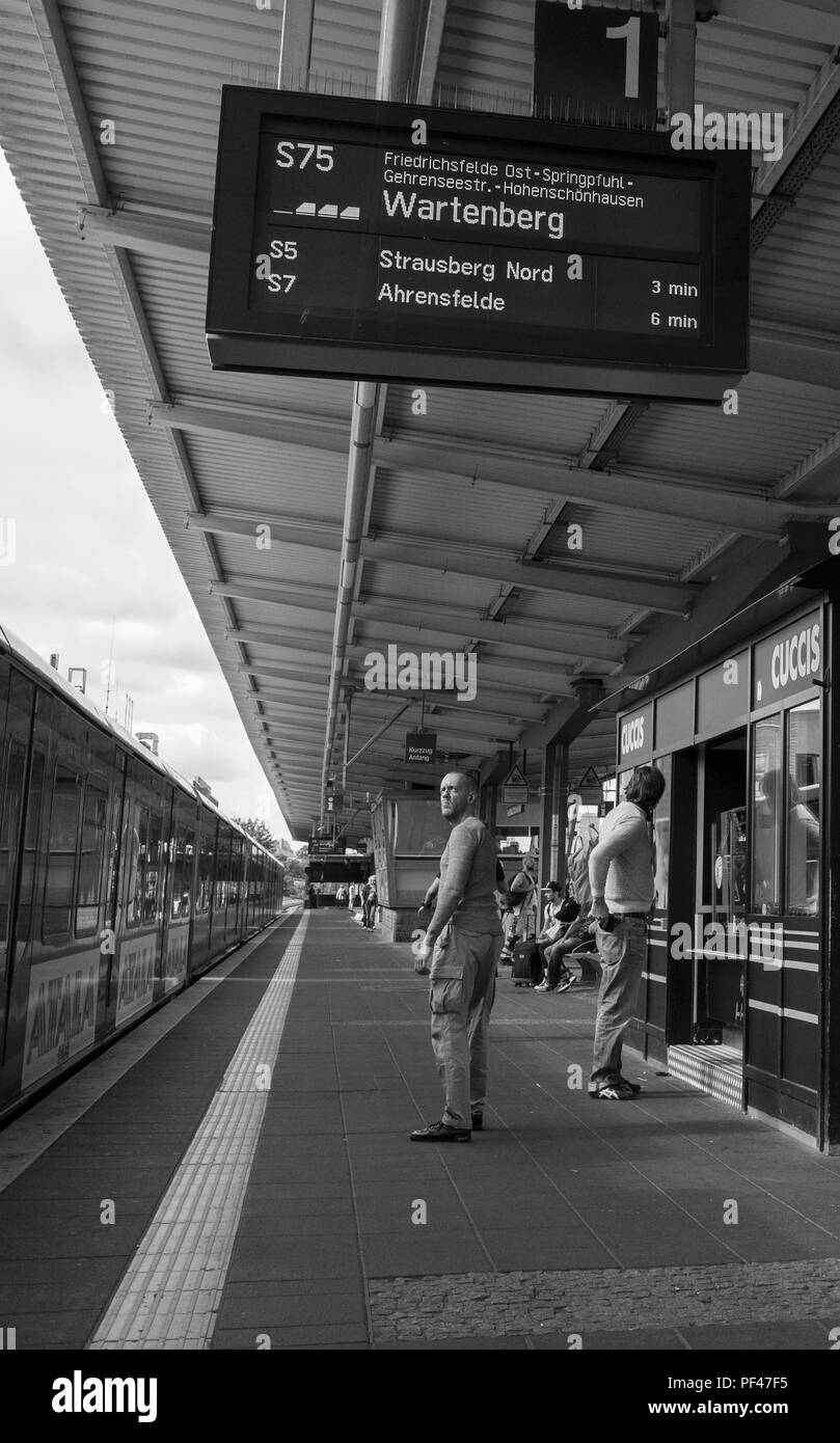 Berlin, Germany, 1st September 2017, A commutor, turns to check the electronic information board, Bahnhof Lichtenber, © Peter SPURRIER, Stock Photo