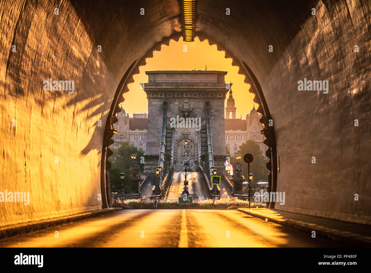Budapest, Hungary - Entrance of the Buda Castle Tunnel at sunrise with Szechenyi Chain Bridge and Academy of Science  building at background Stock Photo