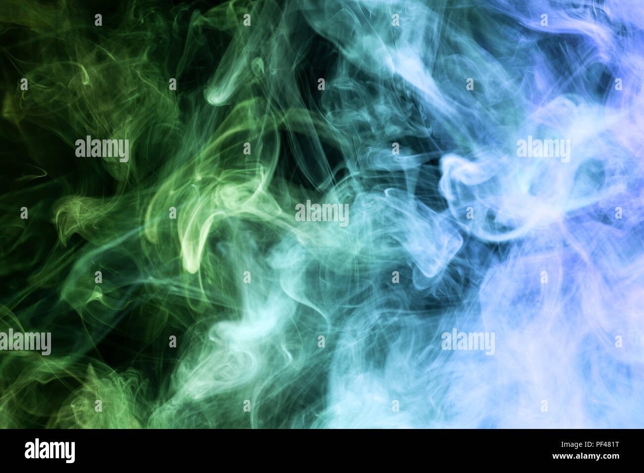 Thick blue and green smoke on a black isolated background. Background ...