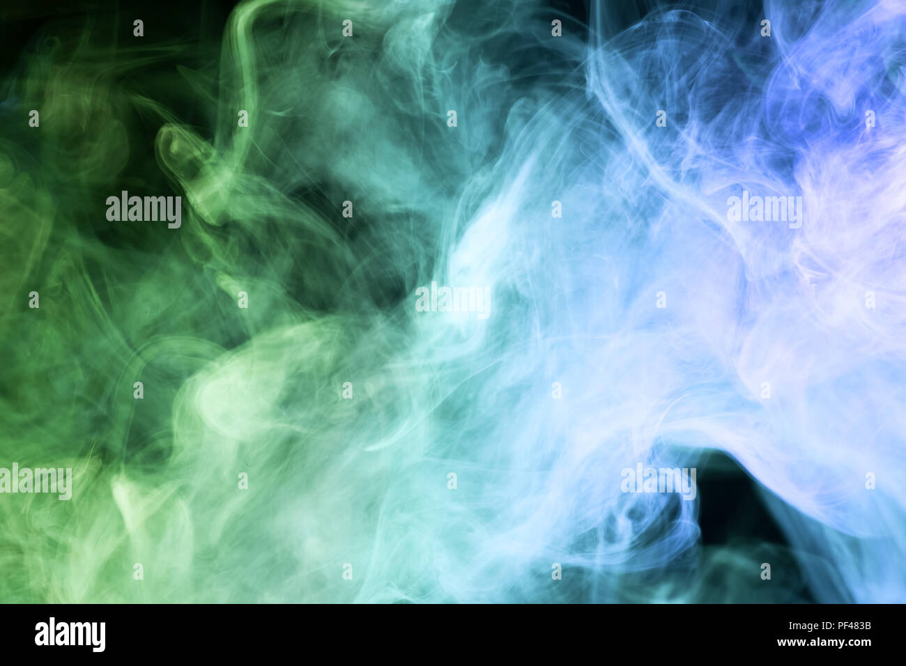 Thick blue and green smoke on a black isolated background. Background ...