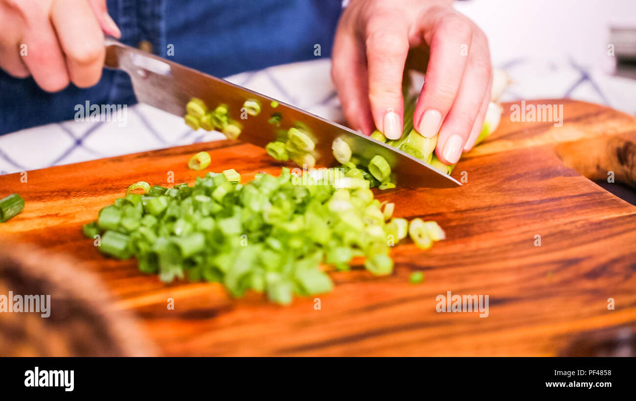Step by step. Slicing green onions on a wood cutting board Stock Photo ...