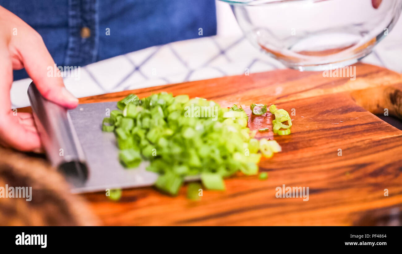 Step by step. Slicing green onions on a wood cutting board Stock Photo ...
