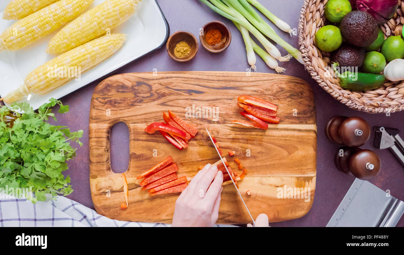 Step by step. Slicing red bell pepper on a wood cutting board Stock ...
