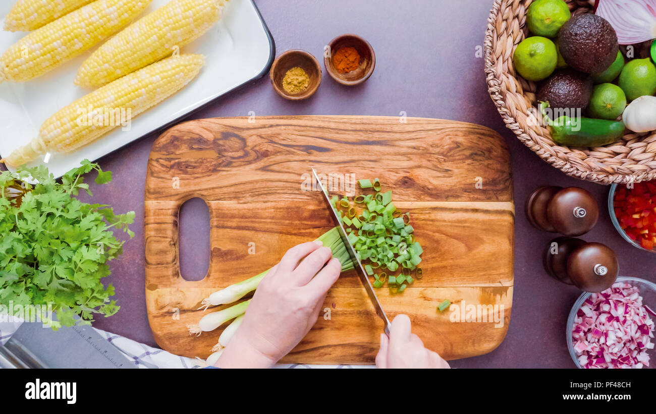 Step by step. Slicing green onions on a wood cutting board Stock Photo ...