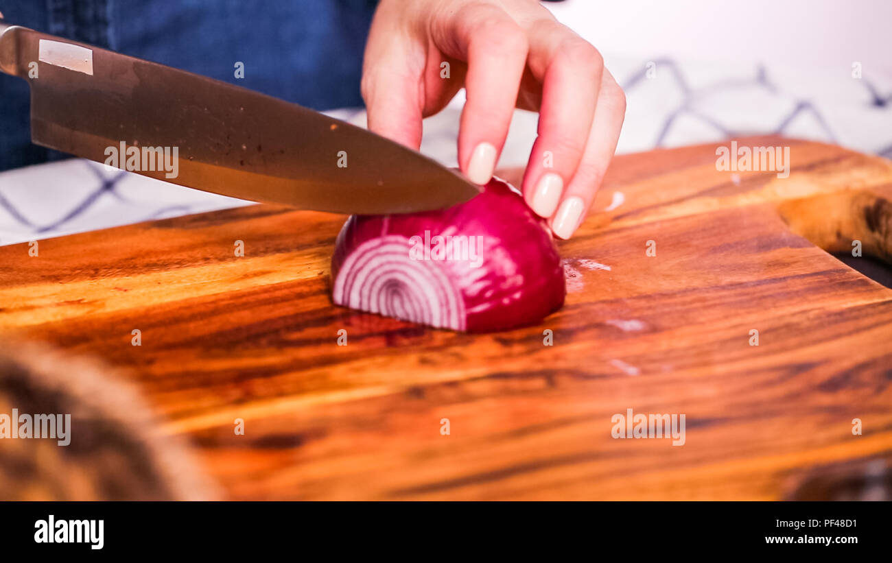 Step by step. Slicing purple onion on a wood cutting board Stock Photo ...