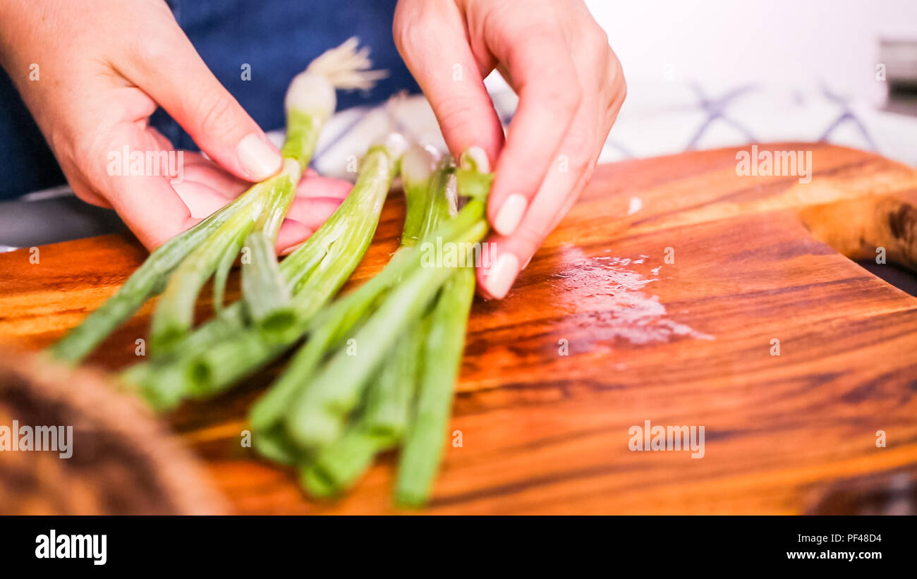 Step by step. Slicing green onions on a wood cutting board Stock Photo ...