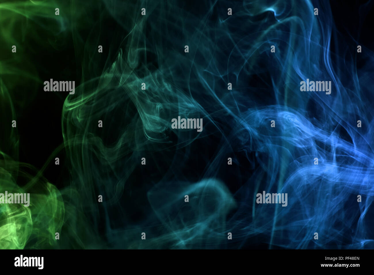 Green and blue smoke on black background Stock Photo - Alamy