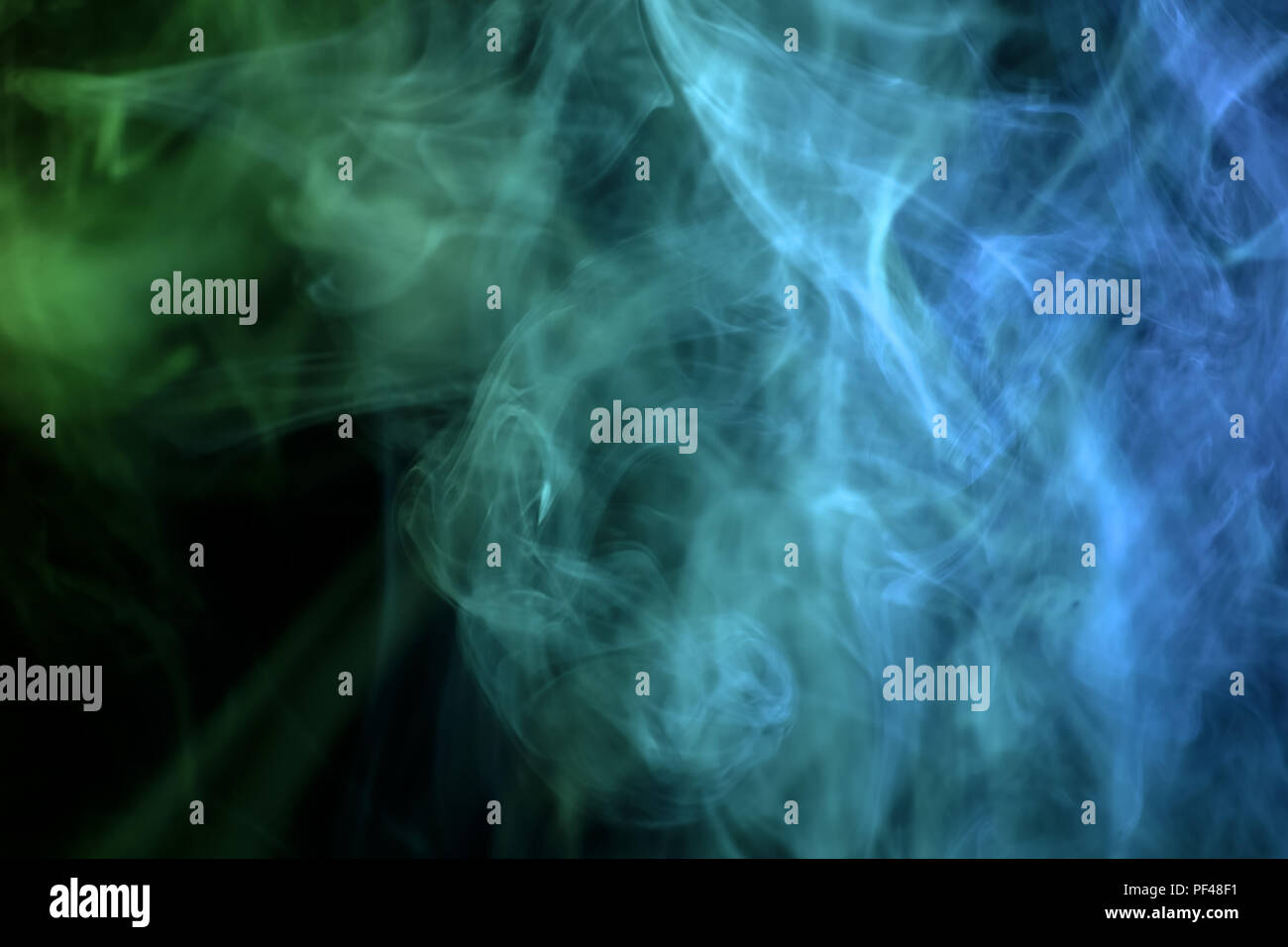 Green and blue smoke on black background Stock Photo - Alamy