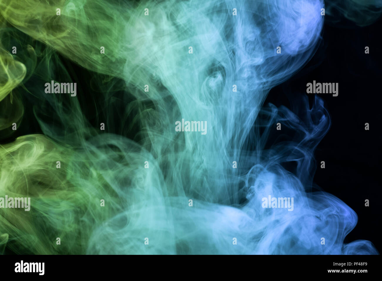 Green and blue smoke on black background Stock Photo - Alamy
