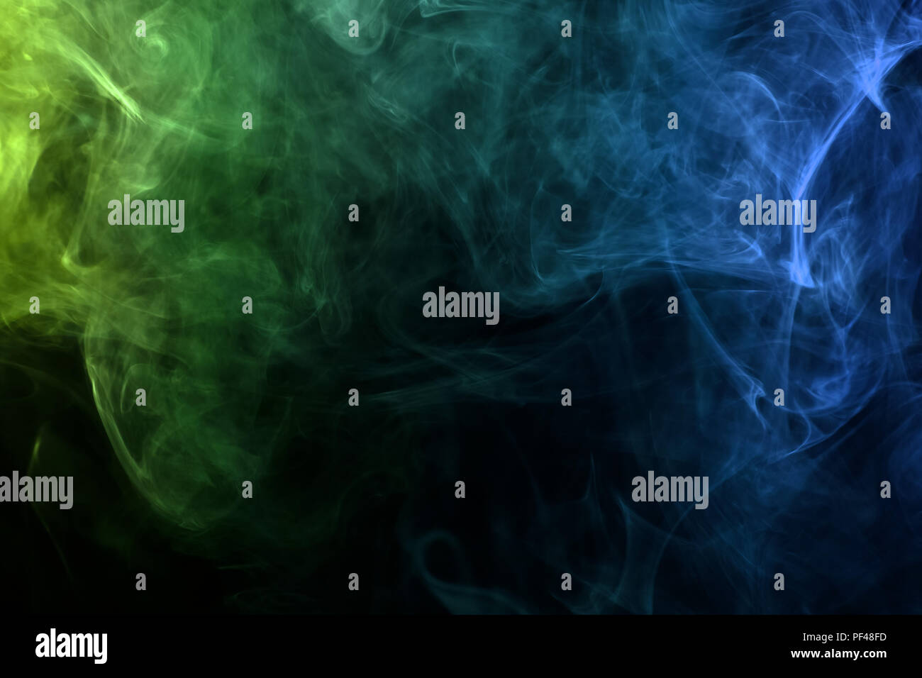 Green and blue smoke on black background Stock Photo - Alamy