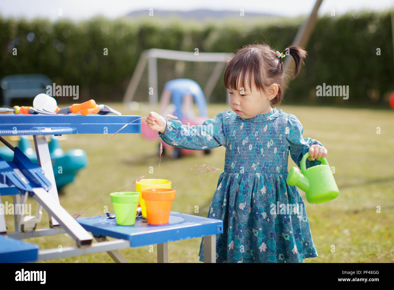 baby girl pretend play in Summer garden Stock Photo Alamy