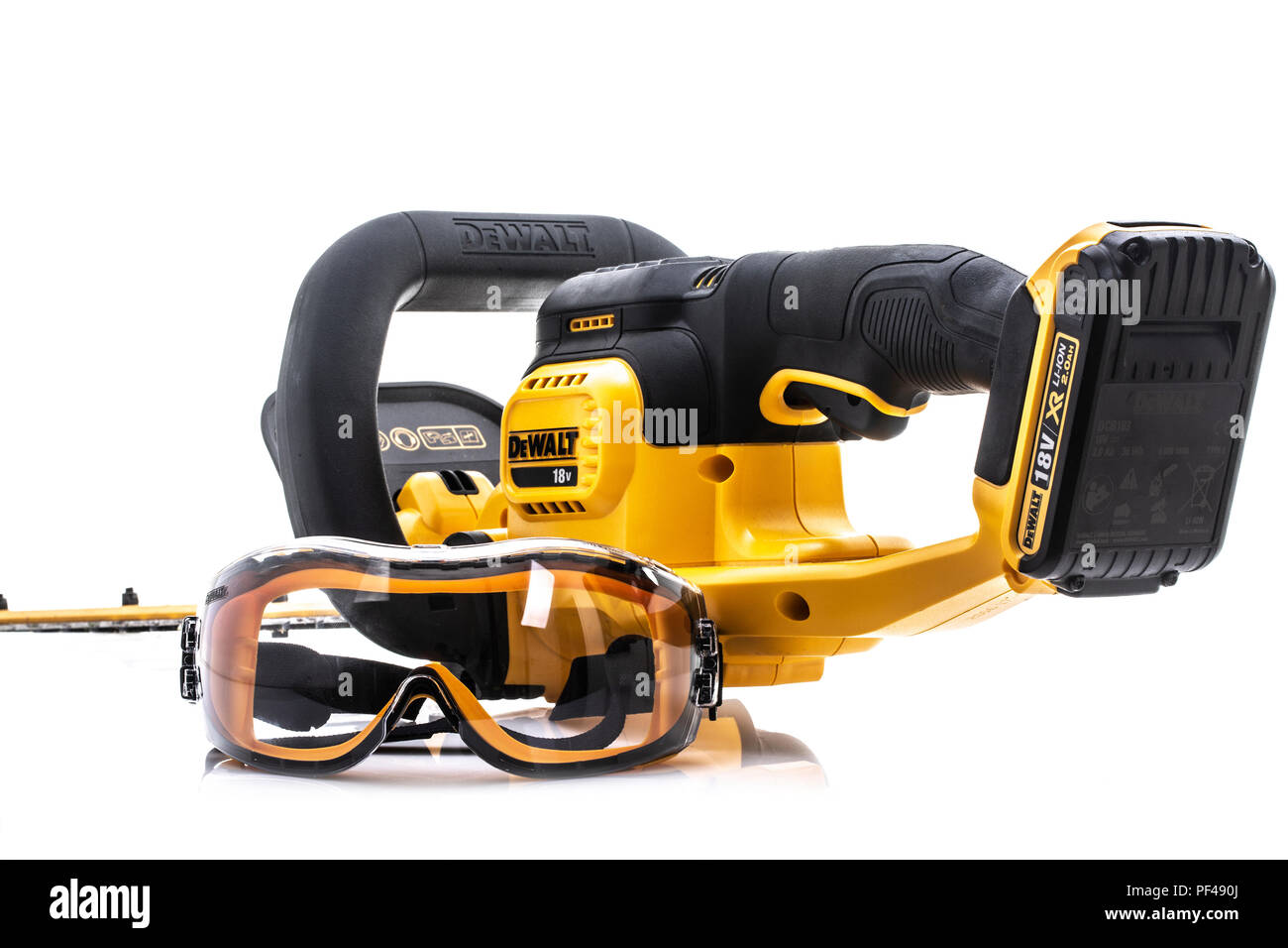 SWINDON, UK - AUGUST 19, 2018: DeWalt cordless Hedge Trimmer and safety glasses on a white background Stock Photo