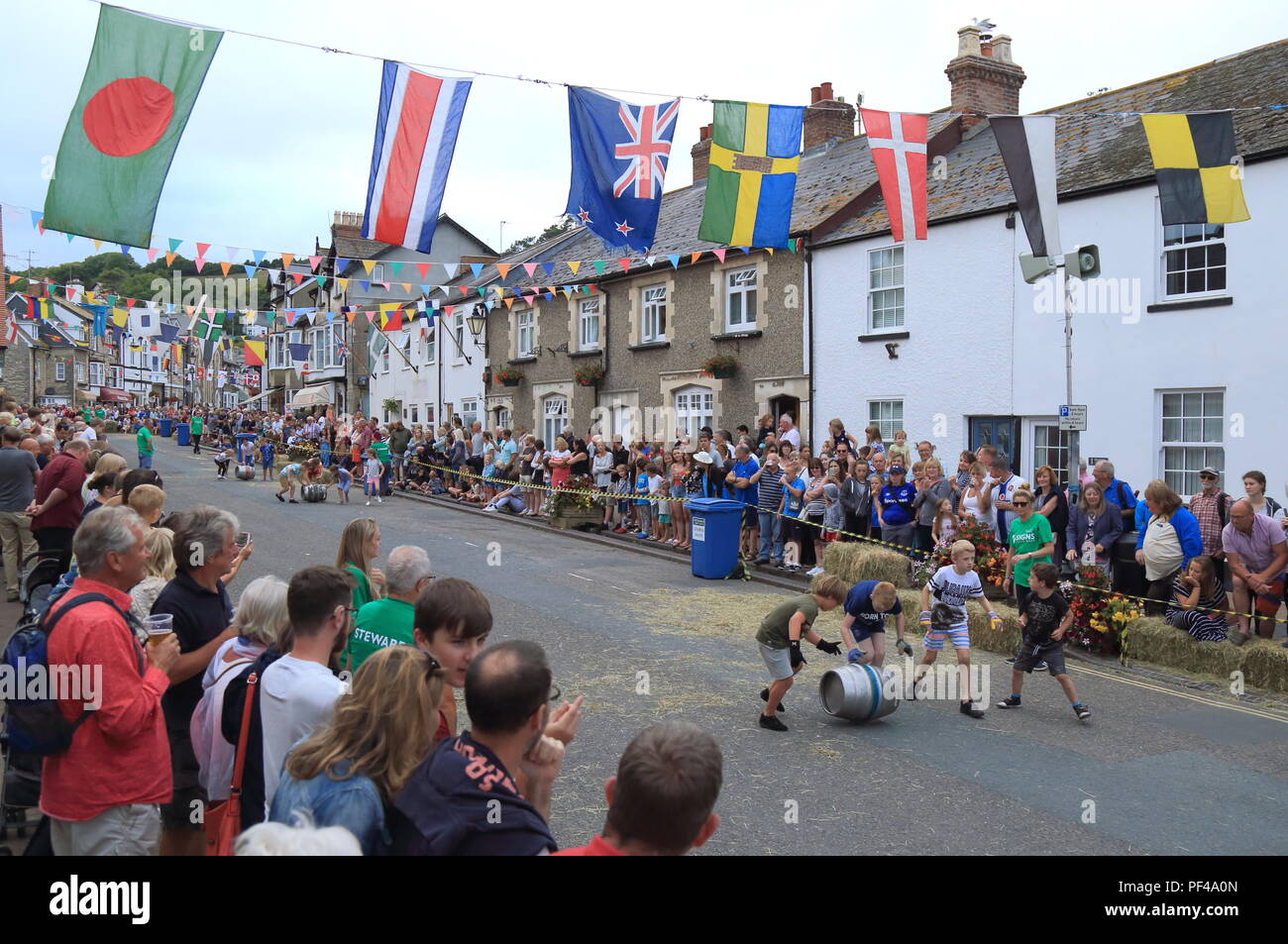 Rolling beer barrels competition on the main street in village of Beer