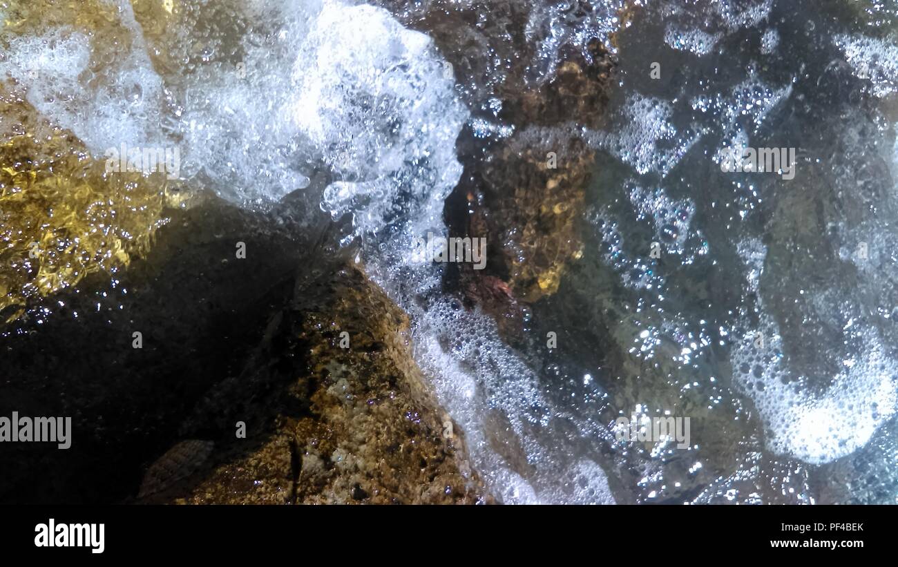 Waves on the rocks Stock Photo