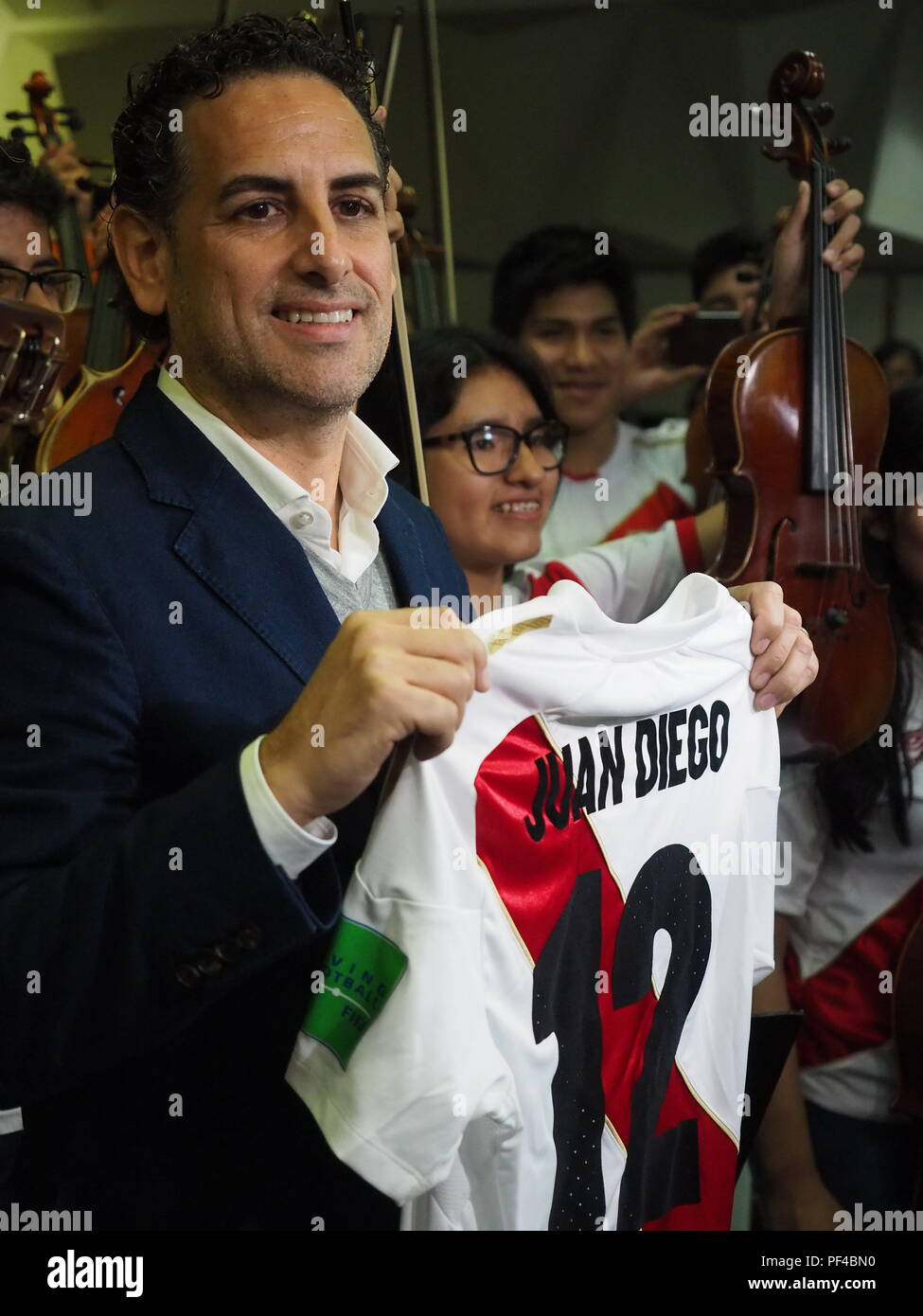 The operatic tenor Juan Diego Florez, together with the children of the Symphony  for Peru Orchestra wearing Peruvian soccer jerseys, singing to the Peruvian soccer team one day before the match against Australia in the Russia 2018 World Cup. Stock Photo