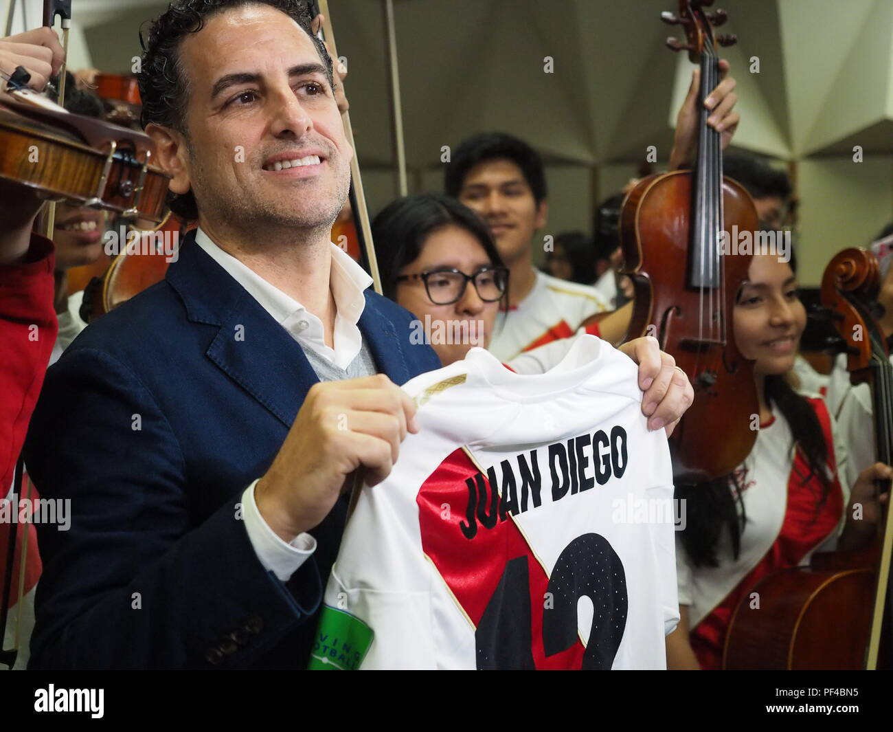 The operatic tenor Juan Diego Florez, together with the children of the Symphony  for Peru Orchestra wearing Peruvian soccer jerseys, singing to the Peruvian soccer team one day before the match against Australia in the Russia 2018 World Cup. Stock Photo