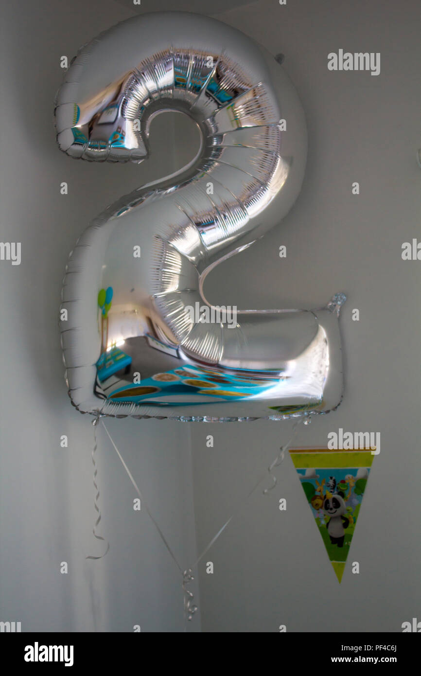 Golden Balloons For 18th Birthday Celebration On Yellow Wall Background