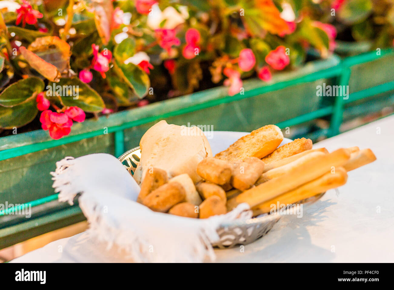 Basket of breads and breadsticks on a table of restaurant Stock Photo
