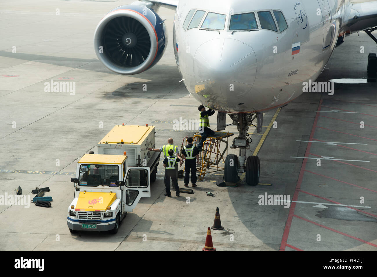 Beijing, China- June 12 2018: Airport engineer staff feeling and servicing an Aeroflot airlines airplane landed on the runway at Beijing capital Inter Stock Photo