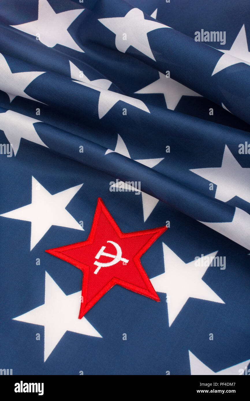 Red Star Hammer and Sickle badge with American Stars & Stripes flag. For US Radical Left, Communist America, Democratic Socialists, American marxism. Stock Photo