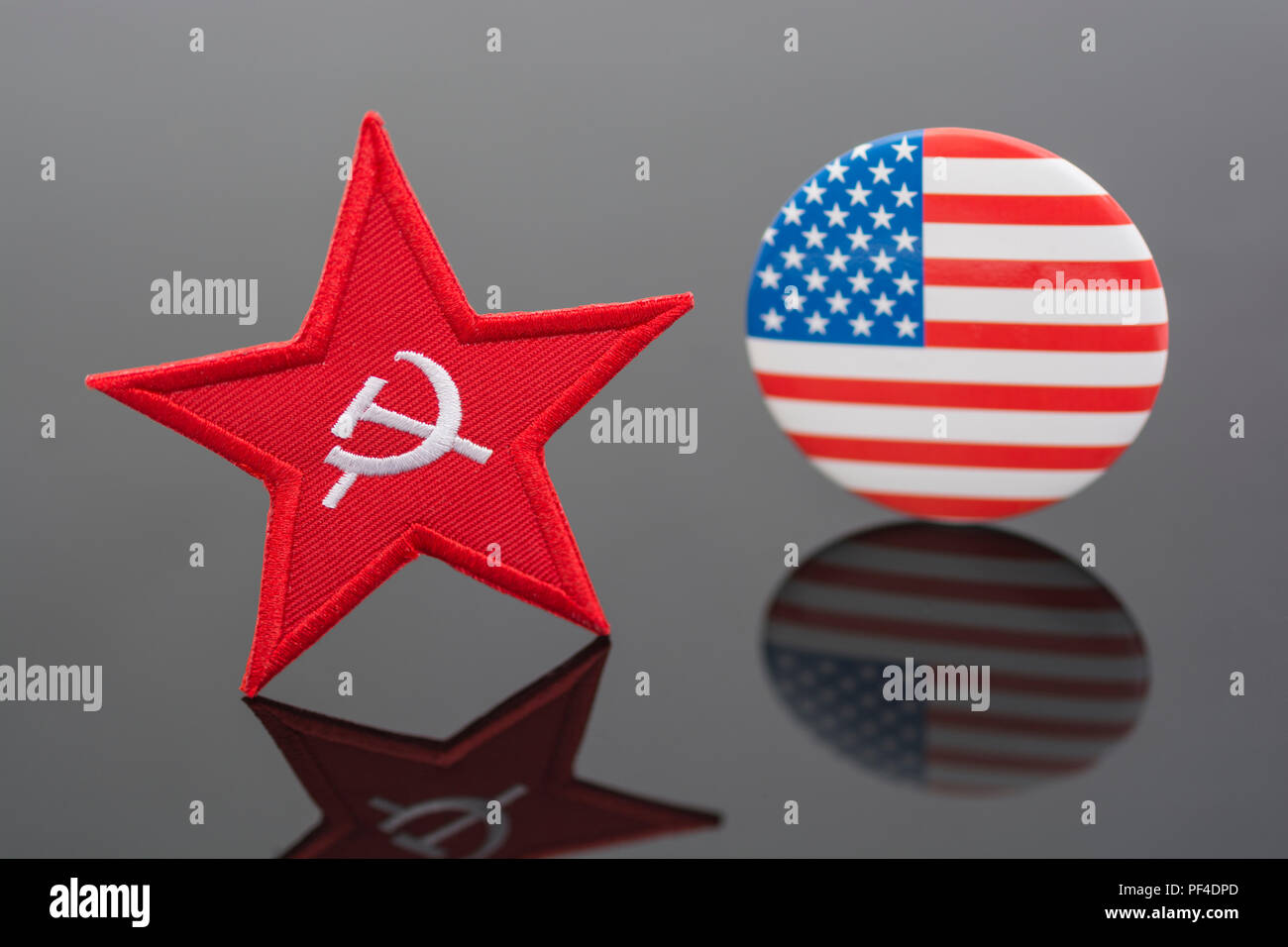 Red Star Hammer & Sickle badge + US / American Stars and Stripes flag. For US Radical Left, Democratic Socialists, Marxist America, US Russia dispute. Stock Photo