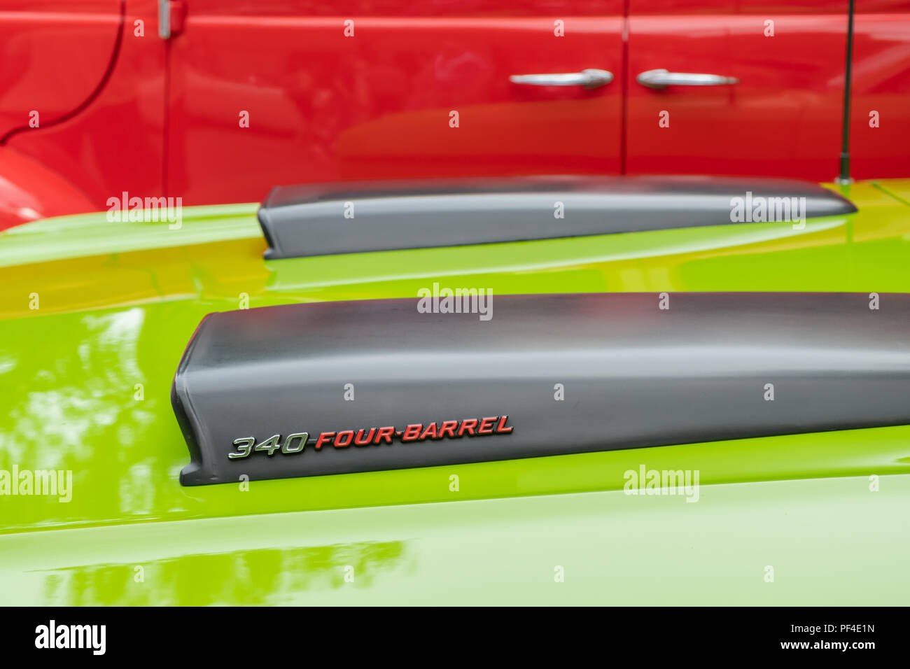 Closeup of a black hoodscoop from a vintage 1971 lime green Dodge Demon. Stock Photo