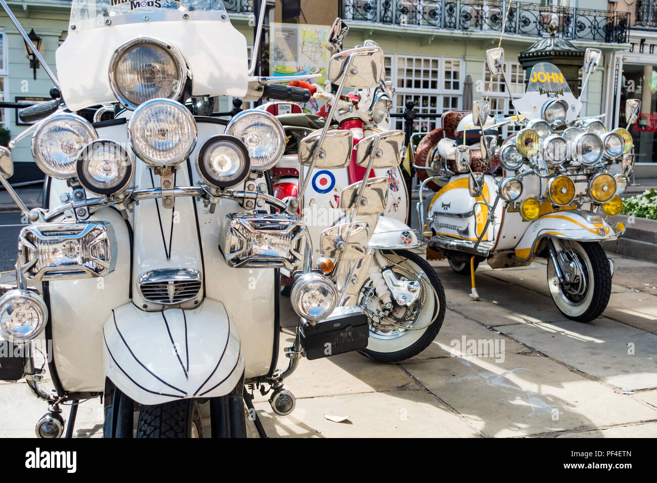 Three heavily modified scooters with extra chrome, headlights and mirrors added parked in Windsor. Stock Photo