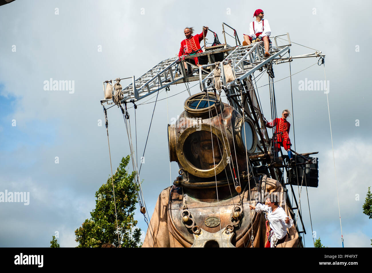 Leeuwarden, The Netherlands, 18th August, 2018. The world-famous production of Royal de Luxe makes its Dutch premiere in the European Capital of Culture. These towering giants walk the streets of Leeuwarden and provide an unforgettable experience with their 'Big Skate in the Ice' show. Royal de Luxe is an extraordinary street theatre company.  Twenty people are needed to make her move and she is Credit: Ricardo Hernandez/Alamy Live News Stock Photo