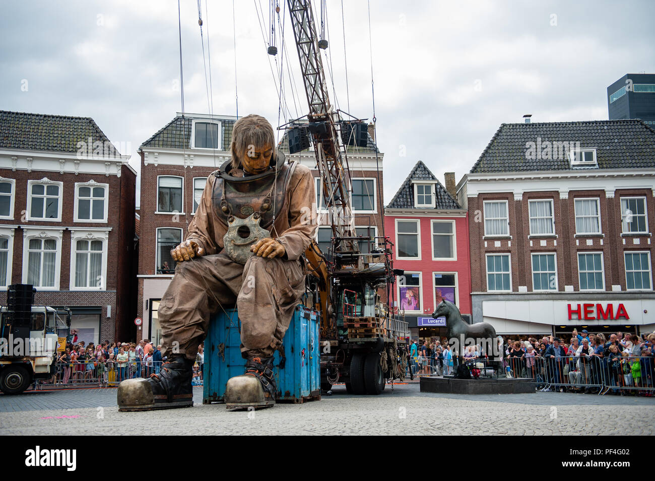 Leeuwarden, The Netherlands, 18th August, 2018. The world-famous production of Royal de Luxe makes its Dutch premiere in the European Capital of Culture. These towering giants walk the streets of Leeuwarden and provide an unforgettable experience with their 'Big Skate in the Ice' show. Royal de Luxe is an extraordinary street theatre company.  Twenty people are needed to make her move and she is Credit: Ricardo Hernandez/Alamy Live News Stock Photo