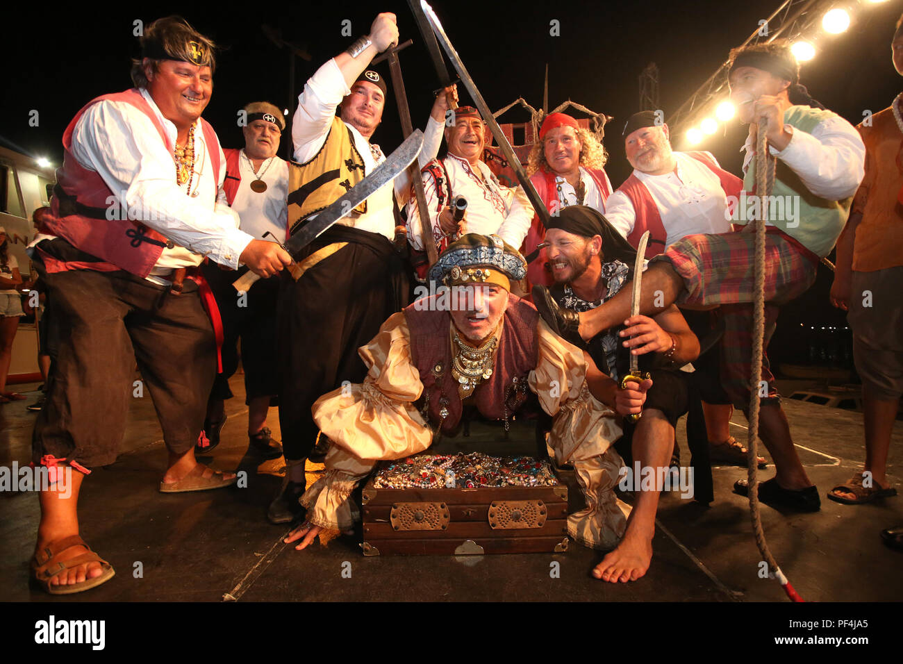 Omis, Croatia. 18th Aug, 2018. Performers in ancient costumes reenact an ancient battle between Omis pirates and the Venetians in Omis, Croatia, on Aug. 18, 2018. Omis pirates won after a fierce battle and ordered the Venetians to pay them a fee in gold coins for safe passage through the Brac channel in the 13th century. Credit: Miranda Cikotic/Xinhua/Alamy Live News Stock Photo
