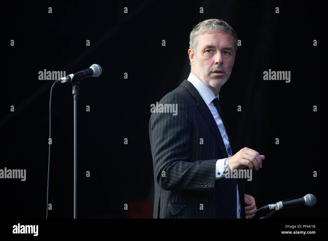 Glanusk Park, Brecon, Wales, 18th August 2018.  Day Two of the Green Man music festival in the Brecon Beacons Mountains in Wales. Pictured: Baxter Dury plays the main Mountain Stage. Credit: Rob Watkins/Alamy Live News Stock Photo