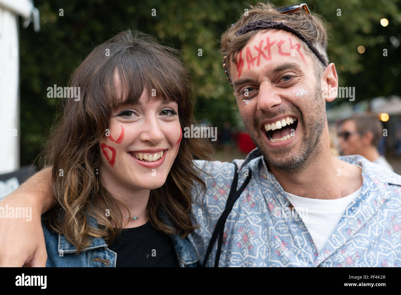 Glanusk Park, Brecon, Wales, 18th August 2018.  Day Two of the Green Man music festival in the Brecon Beacons Mountains in Wales. Pictured: Baxter Dury signed these fans' faces! Credit: Rob Watkins/Alamy Live News Stock Photo