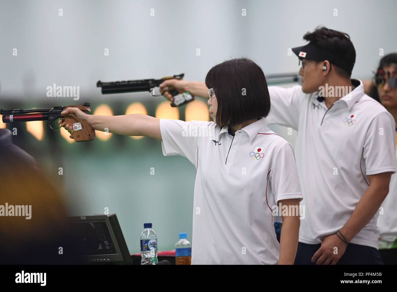 Palembang. 19th Aug, 2018. Sato Akiko (L) and Matsuda Tomoyuki of Japan compete during the 10m Air Pistol Mixed Team Qualification at the 18th Asian Games in Palembang, Indonesia Aug. 19, 2018. Credit: Liu Ailun/Xinhua/Alamy Live News Stock Photo