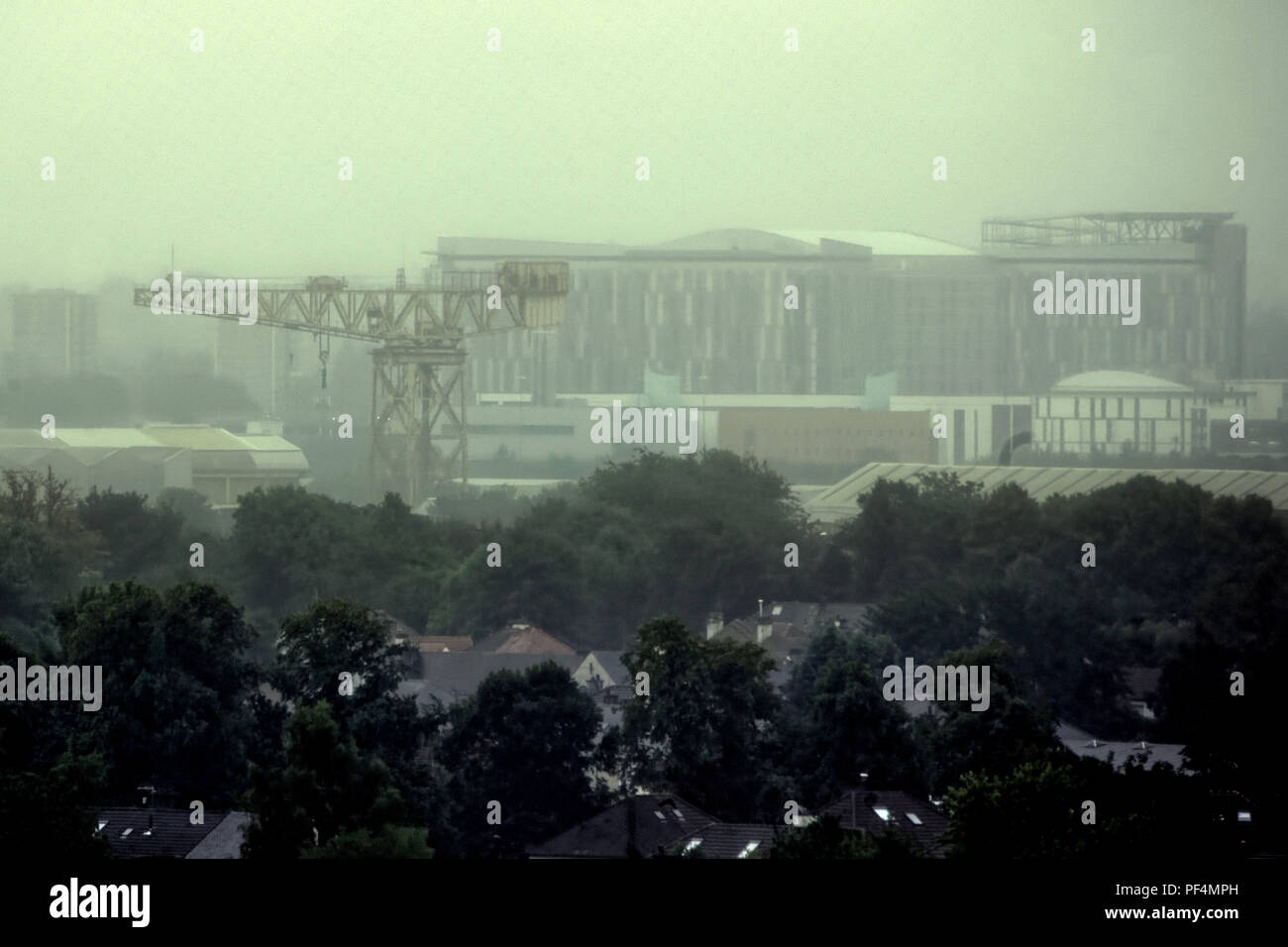 Glasgow, Scotland, UK. 19th August, 2018. UK Weather: Overcast sky as storm Ernesto is due over the town as heavy rain and mist  is forecast through the day.No distant skyline as the city’s landmarks are ghosted behind the suburban semi detached of Knightswood. Gerard Ferry/Alamy news Stock Photo