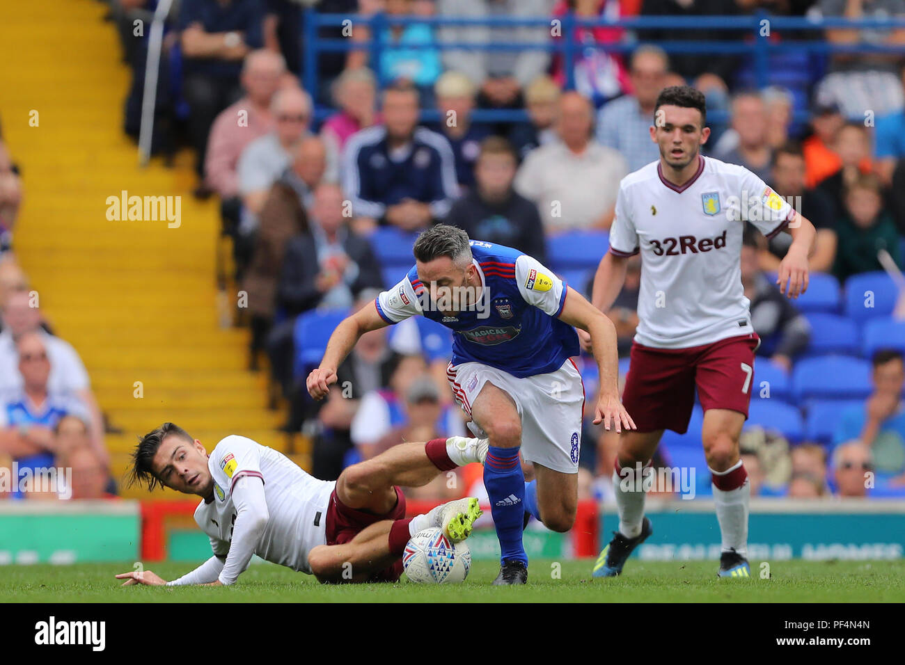 Ipswich, UK.. 18th Aug, 2018. Cole Skuse of Ipswich Town and Jack Grealish of Aston Villa battle for possession - Ipswich Town v Aston Villa, Sky Bet Championship, Portman Road, Ipswich - 18th August 2018 Credit: Richard Calver/Alamy Live News Stock Photo