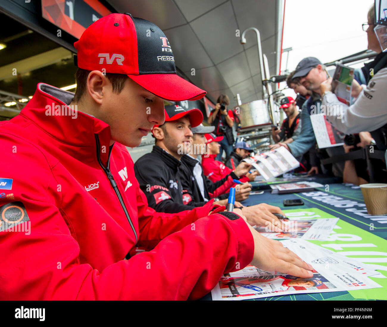 Silverstone Circuit, UK. 19th Aug, 2018. FIA World Endurance Championship; Thomas Laurent (FRA) of the Rebellion R13 Gibson LMP1 racing car from Rebellion Racing (CHE) signing autographs outside the pit garage at Round 3 of the FIA World Endurance Championship at Silverstone Credit: Action Plus Sports/Alamy Live News Stock Photo