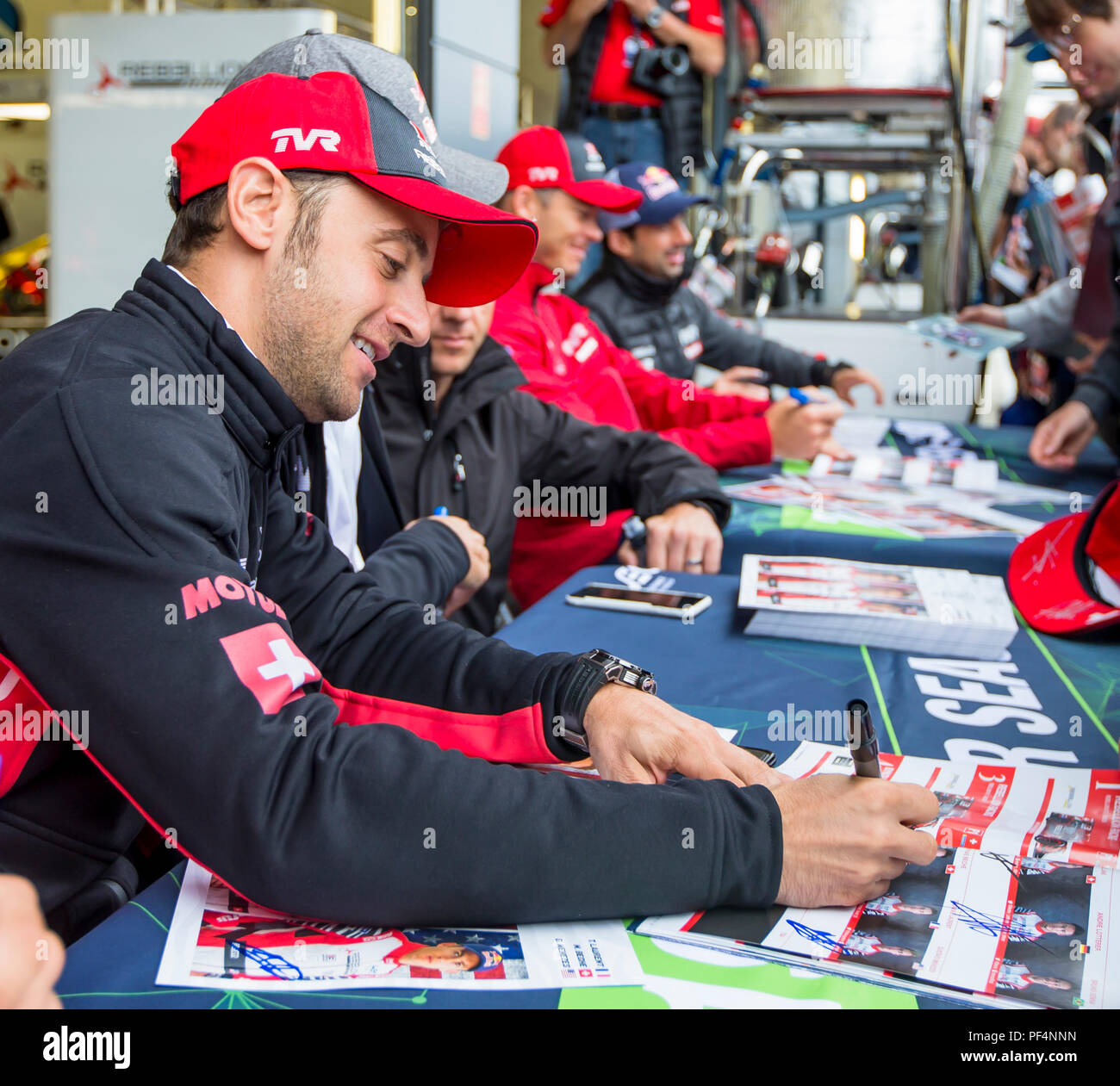 Silverstone Circuit, UK. 19th Aug, 2018. FIA World Endurance Championship; Mathias Beche (SUI) of the Rebellion R13 Gibson LMP1 racing car from Rebellion Racing (CHE) signing autographs outside the pit garage at Round 3 of the FIA World Endurance Championship at Silverstone Credit: Action Plus Sports/Alamy Live News Stock Photo