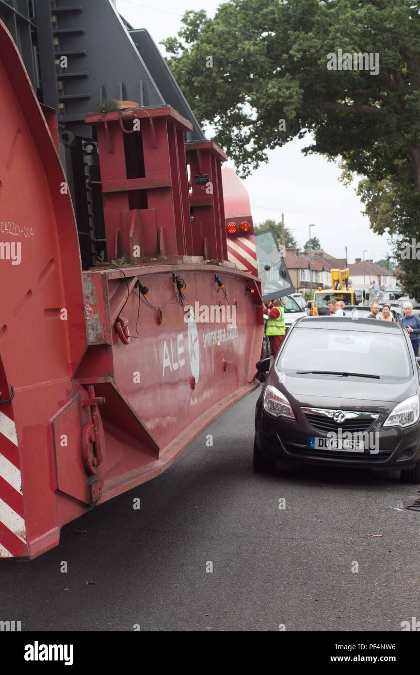 Surrey, UK. 19 August 2018.  68m long lorry carrying a electrical transformer navigates the narrow streets of Surrey. Credit: Andrew Spiers/Alamy Live News Stock Photo