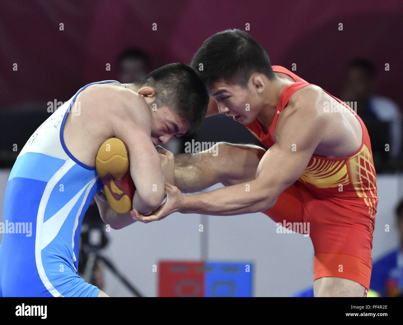 Jakarta, Indonesia. 19th Aug, 2018. Liu Minghu (R) of China competes during the Men's Freestyle 57kg Semifinals with Kang Kum Song of the Democratic People's Republic of Korea (DPRK) at the 18th Asian Games in Jakarta, Indonesia, Aug. 19, 2018. Credit: Li He/Xinhua/Alamy Live News Stock Photo
