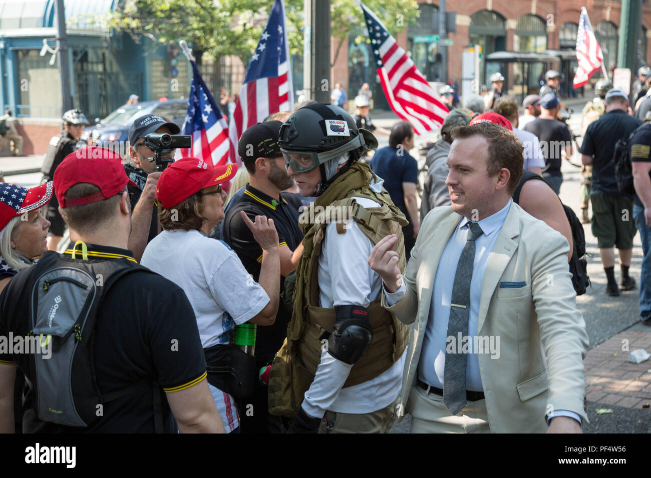 Seattle, WA, USA.  18th August, 2018. A counterprotester Chase, tries to have a dialog with pro gun supporters during a rally  near the King County Court building.  Credit: Maria S./Alamy Live News. Stock Photo
